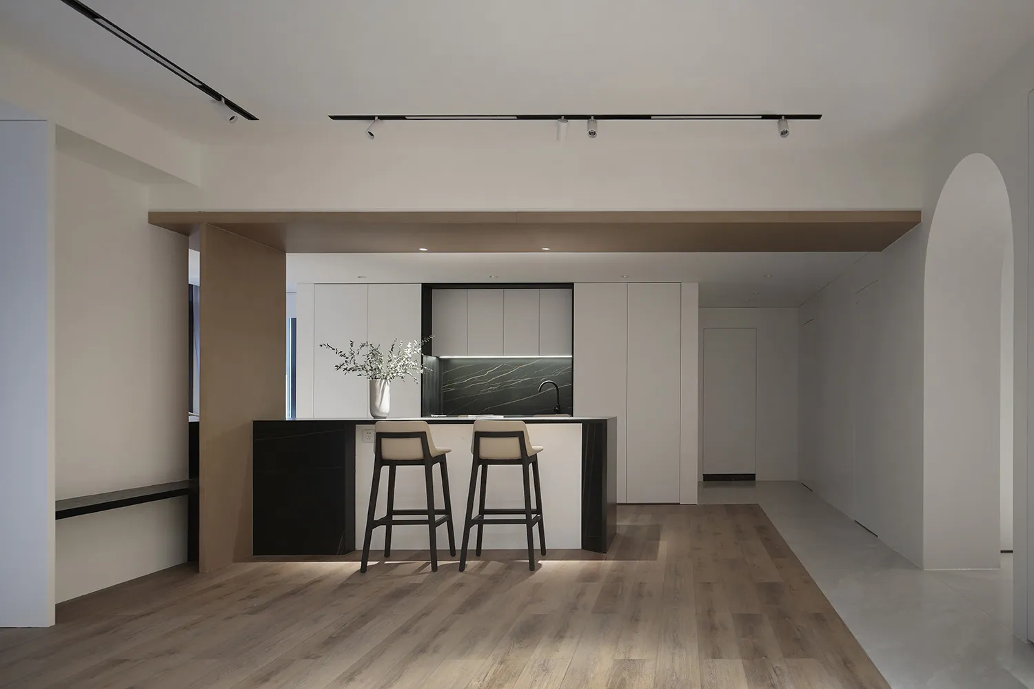 A modern residential kitchen with a concrete countertop and marble accents.