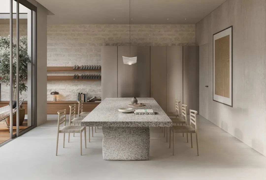 A modern dining room featuring a granite table and wooden chairs.