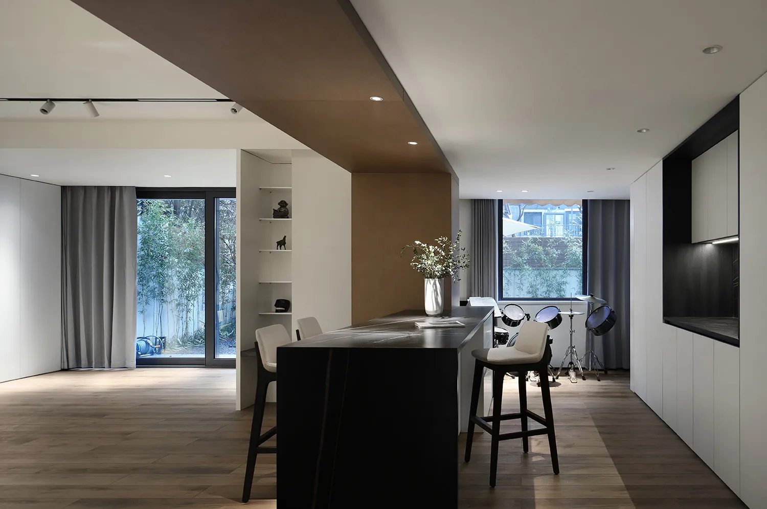 A modern kitchen with a concrete countertop and minimalist design.