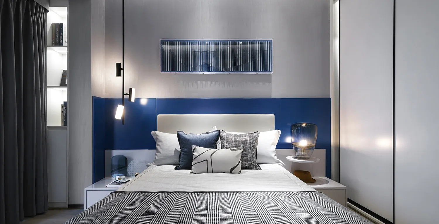 Modern bedroom featuring metallic accents and fabric upholstery, showcasing contemporary design elements.