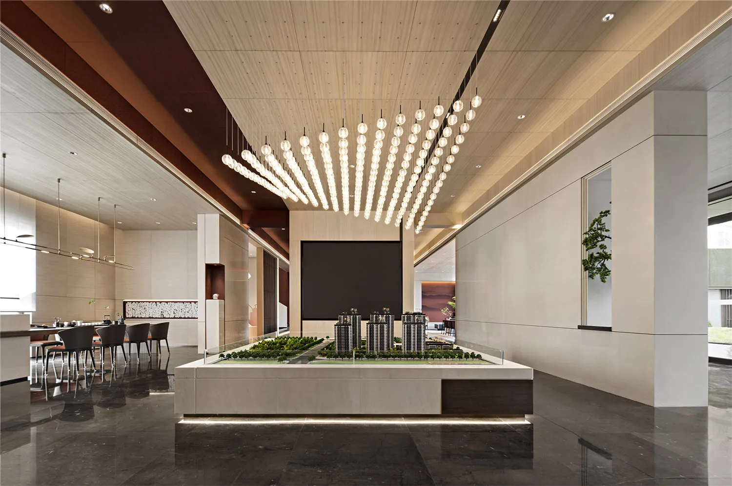A modern commercial interior with luxurious design elements and mixed materials, featuring a model of buildings and a well-li