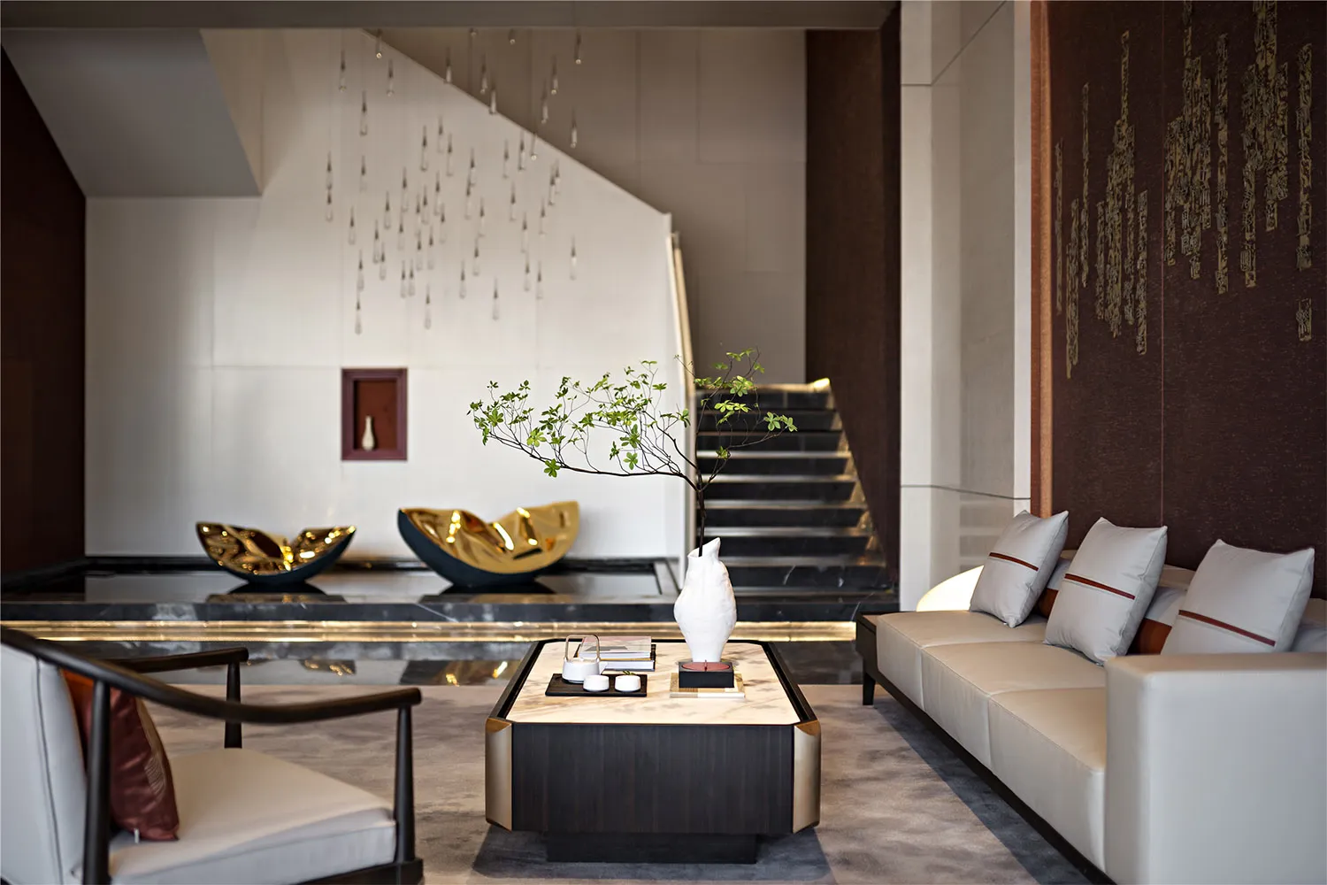 Modern minimalist living room with concrete walls, marble accents, and metallic furniture.