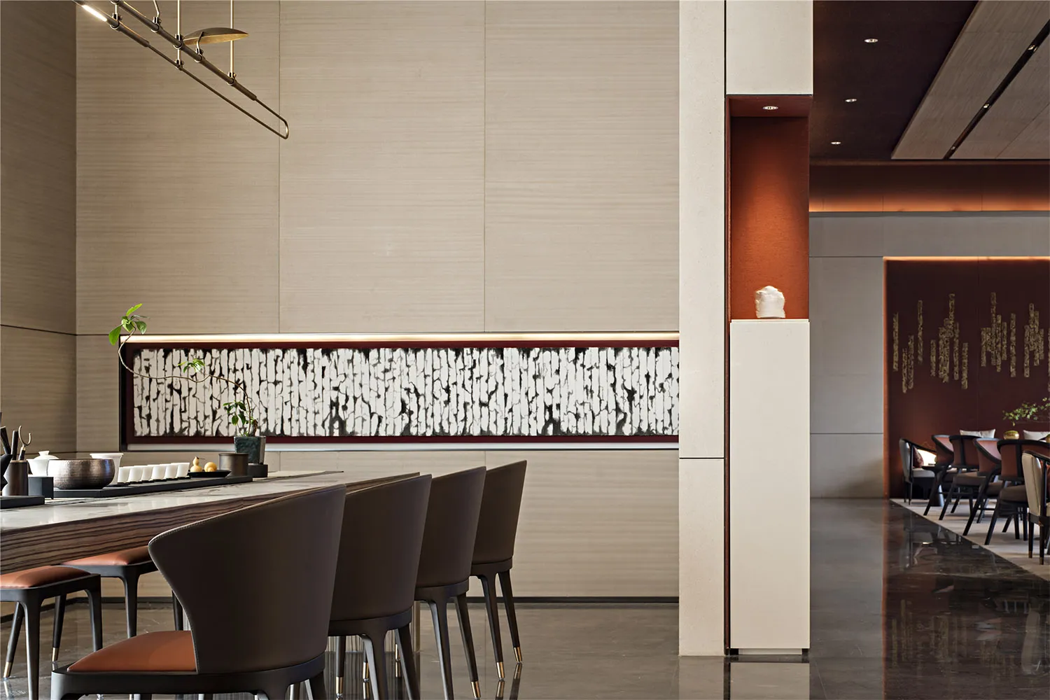 Modern restaurant interior featuring wooden furniture, marble counter, and metal accents.