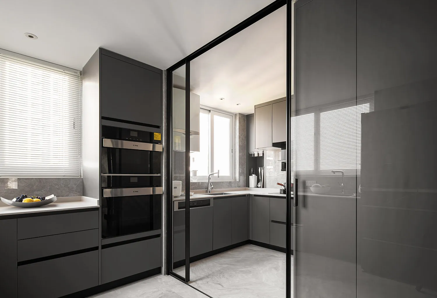 Modern kitchen featuring grey marble countertops and glass cabinets