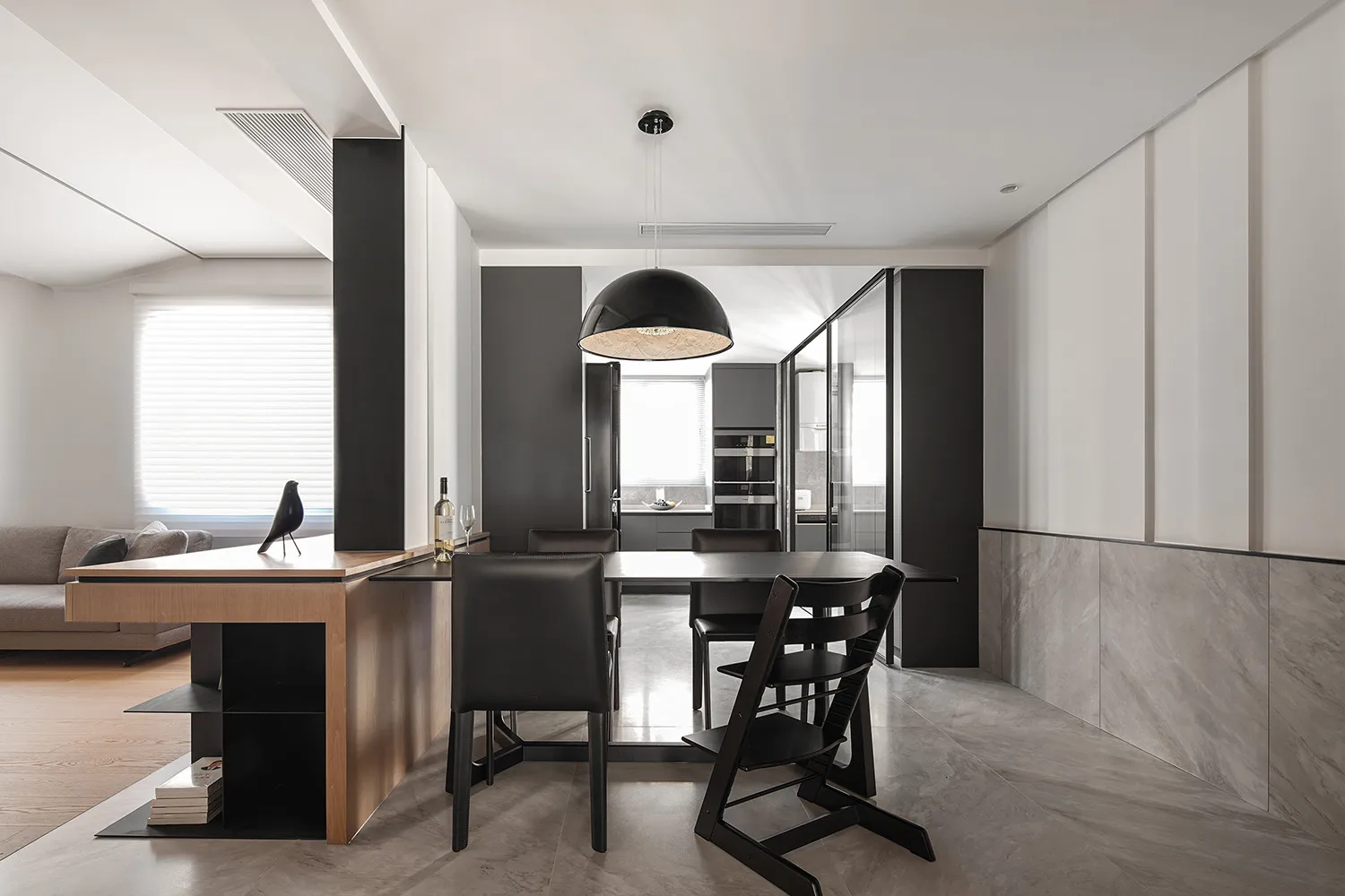 Modern minimalist kitchen with a breakfast bar made of wood and metal materials.