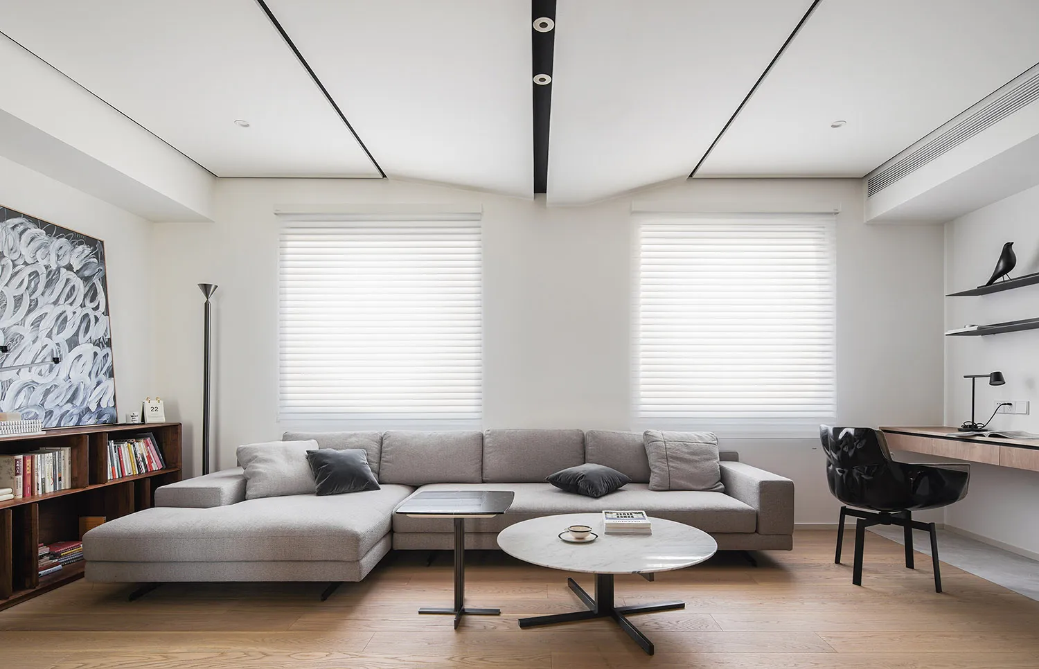 Modern living room with neutral tones and a minimalist design.