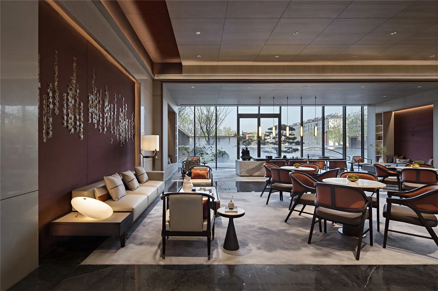 A modern restaurant seating area with glass tables, wooden chairs, and a sleek, smooth floor.