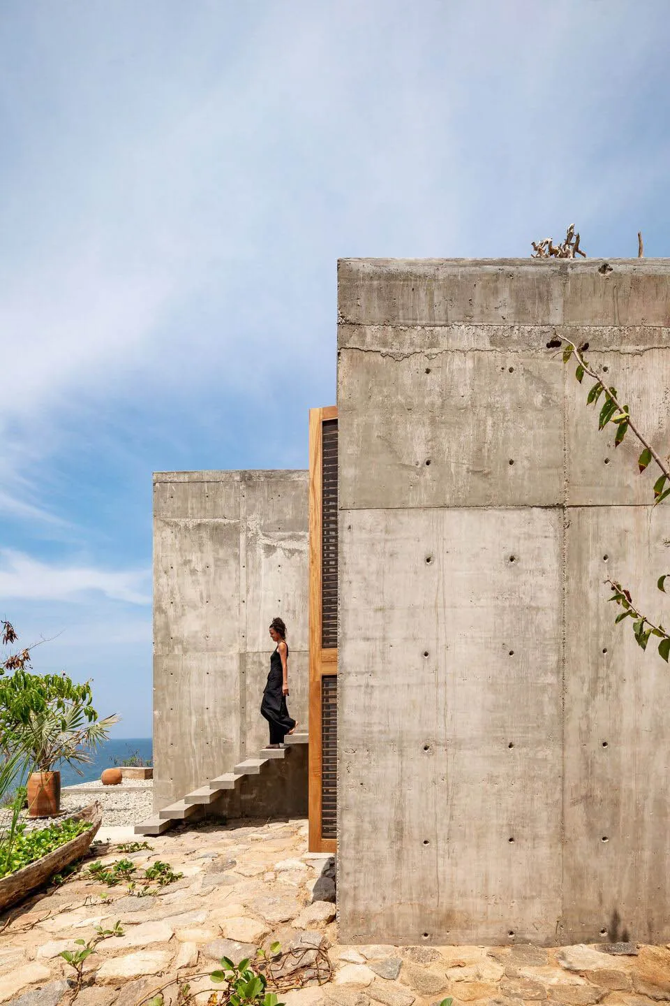 A modern concrete staircase with plants in a garden setting.