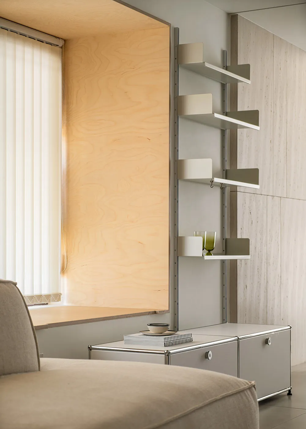 A modern minimalist living room featuring metal shelves.