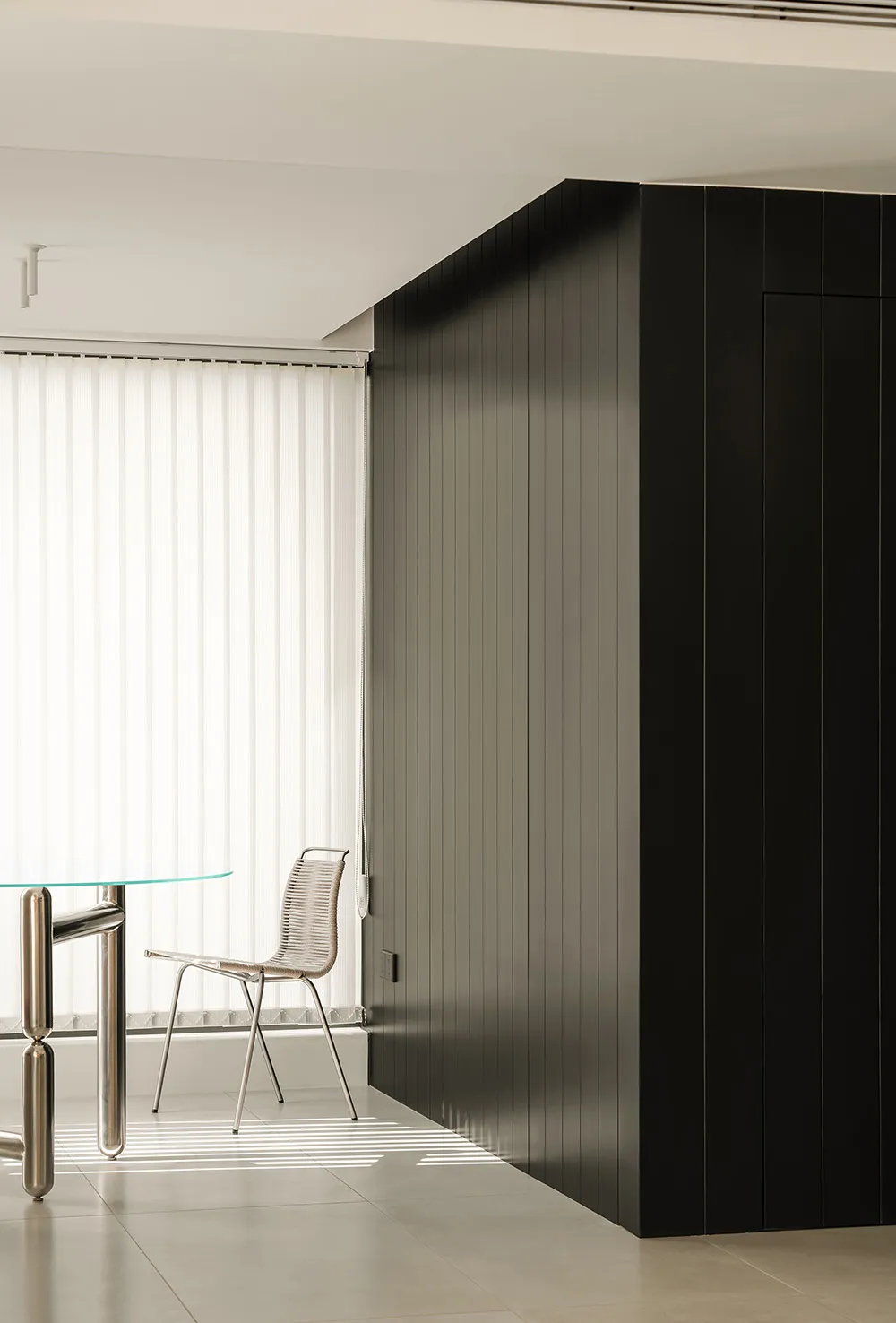 A modern office space featuring black glass paneling walls.