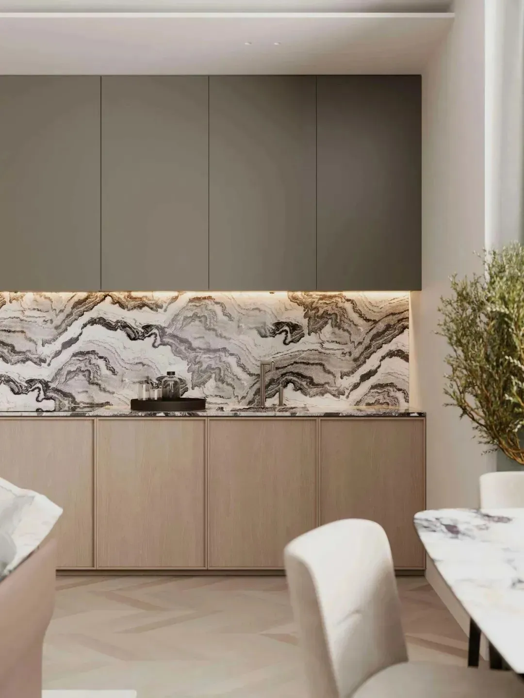 Modern kitchen with marble countertops and backsplash, wooden cabinets, and white seating.
