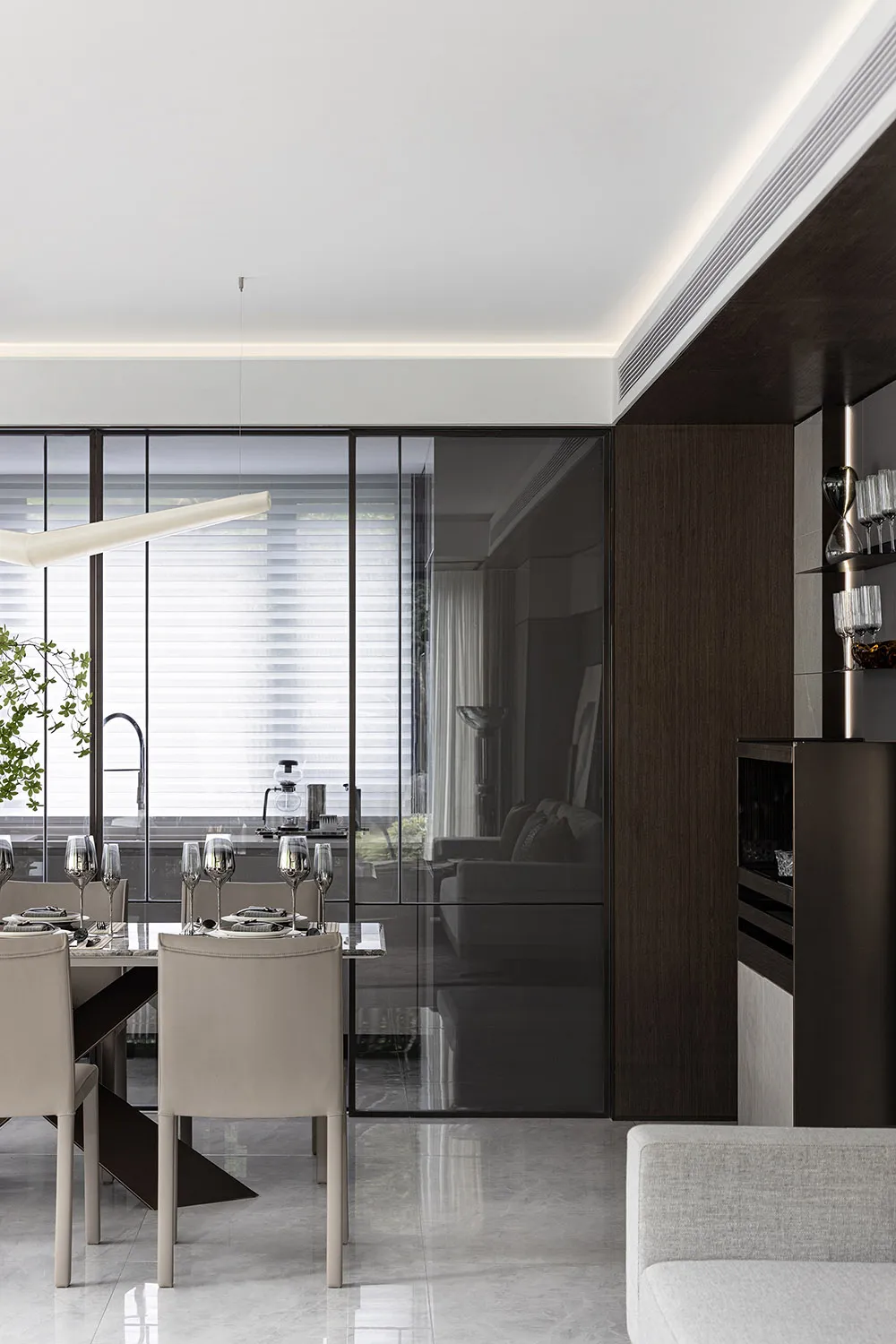 Modern dining room featuring glass, metal, and leather materials