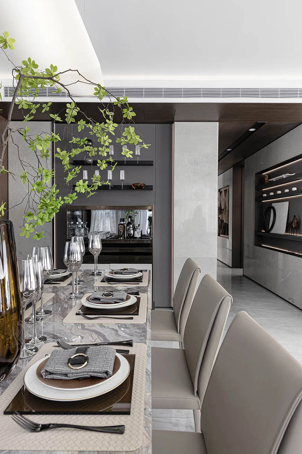 Modern dining room featuring a marble table and bench seating.