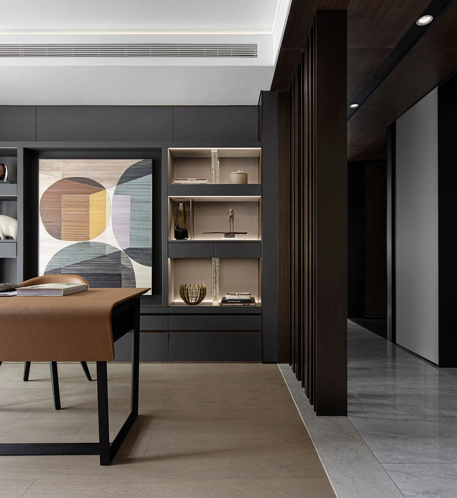 A minimalist booking office with black furnishings and decor.