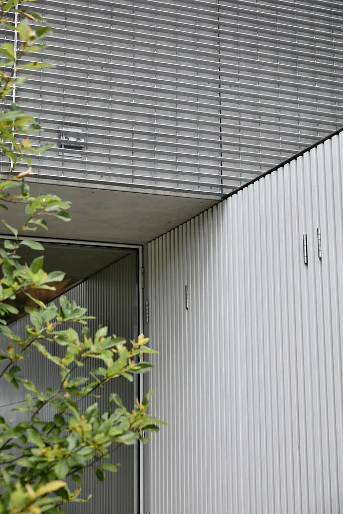 Modern house exterior featuring metal cladding and concrete materials