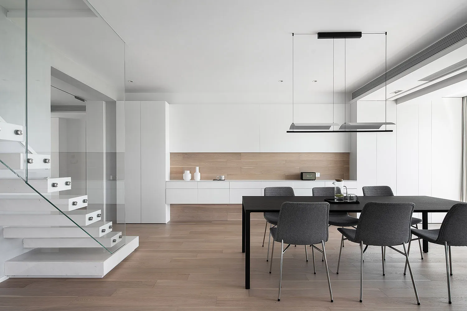 Modern kitchen featuring glass and metal elements with wooden accents