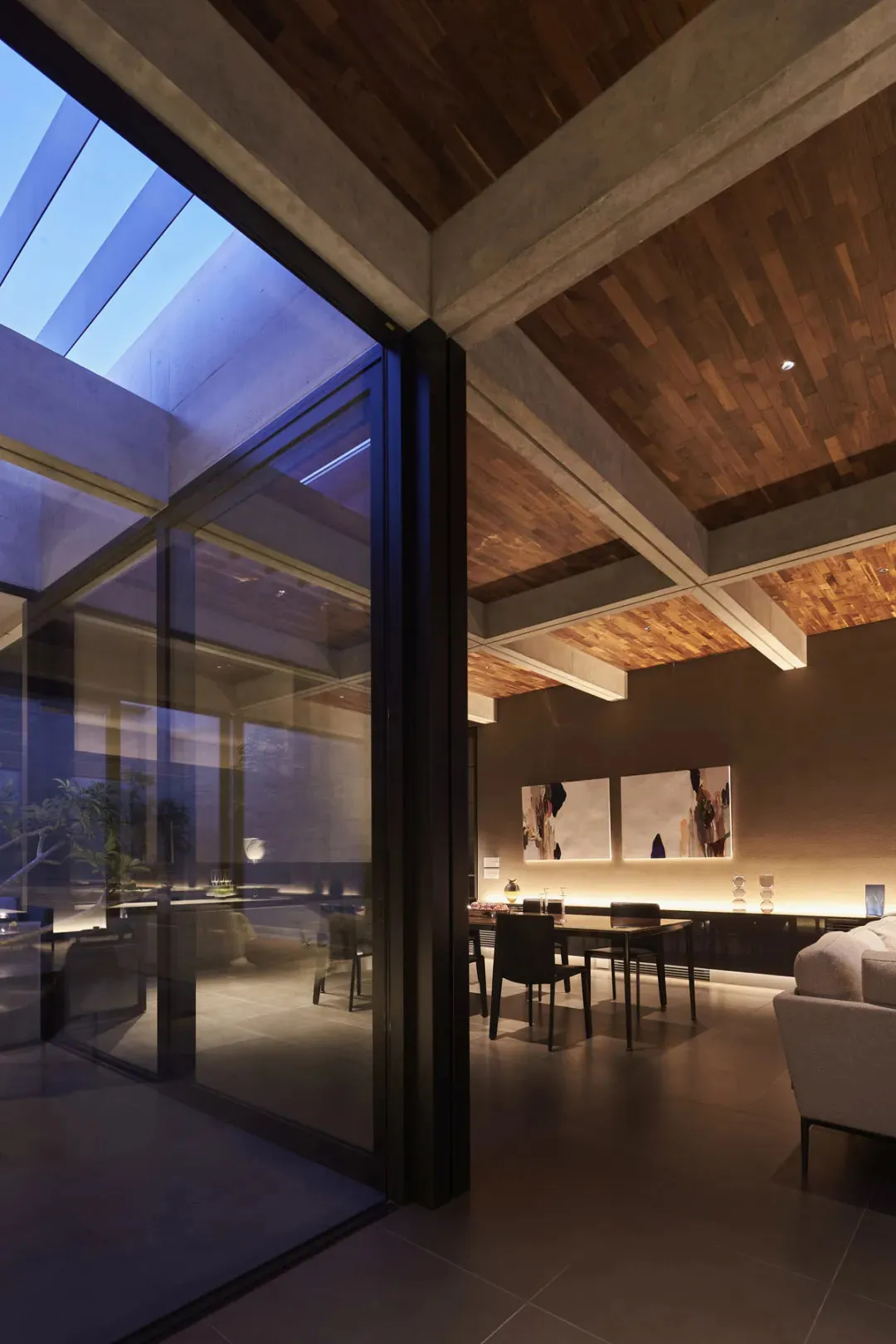 Modern living room with mixed materials and high ceilings.