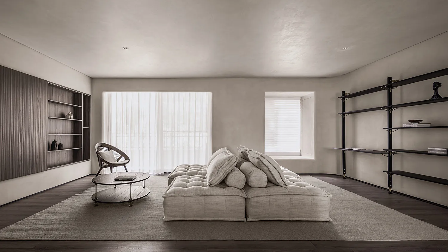 A modern living room featuring neutral-toned leather furniture and minimalist design.
