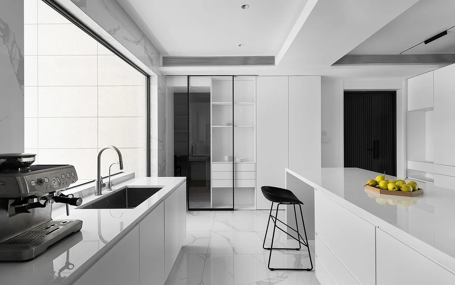 Modern, minimalist kitchen with white marble countertops and floor.