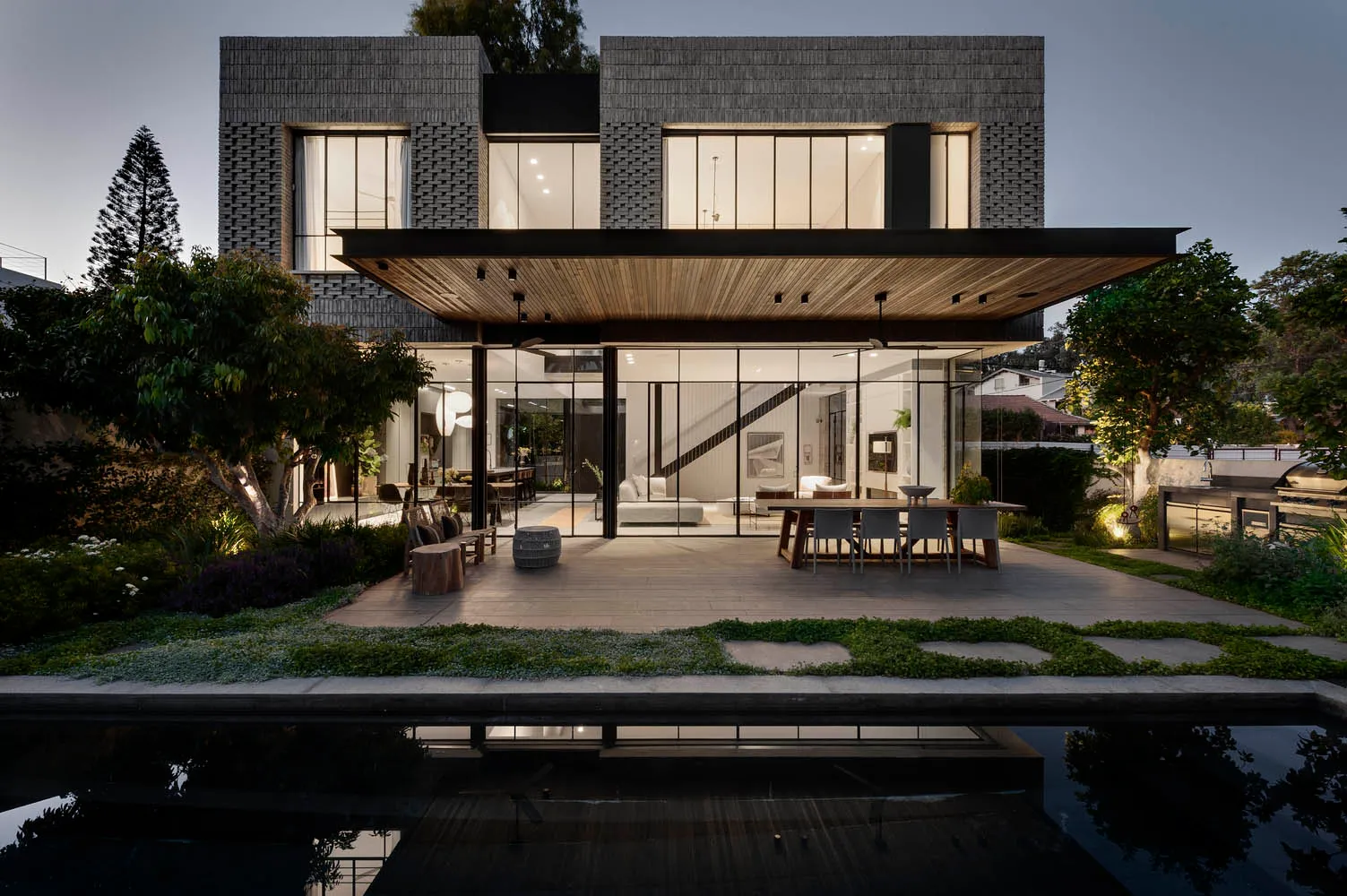 Modern residential building with brick exterior and large windows.