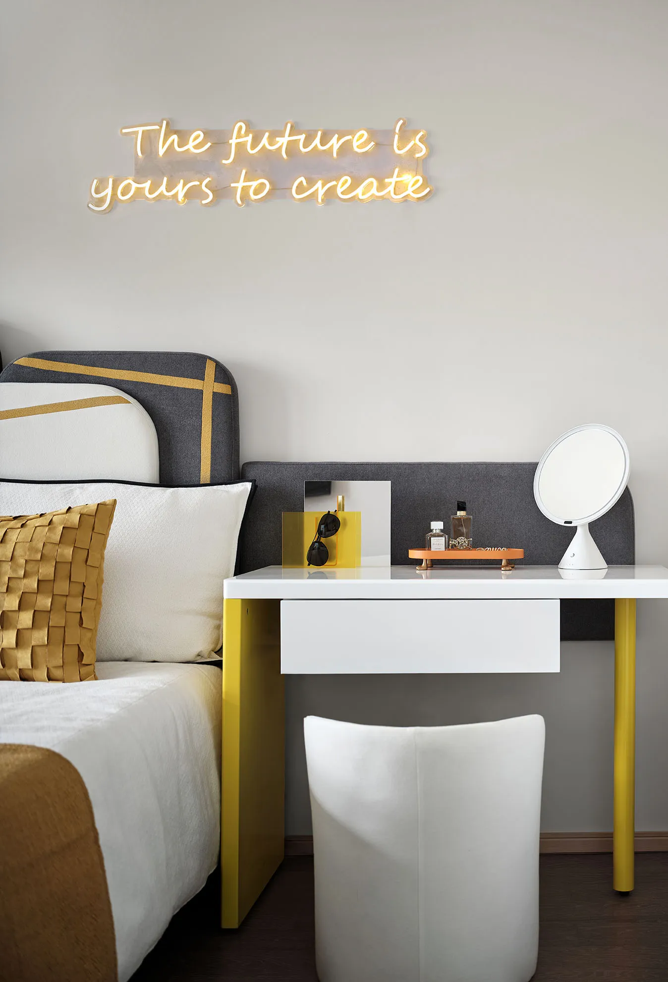 A modern bedroom featuring white concrete walls and a glass headboard.