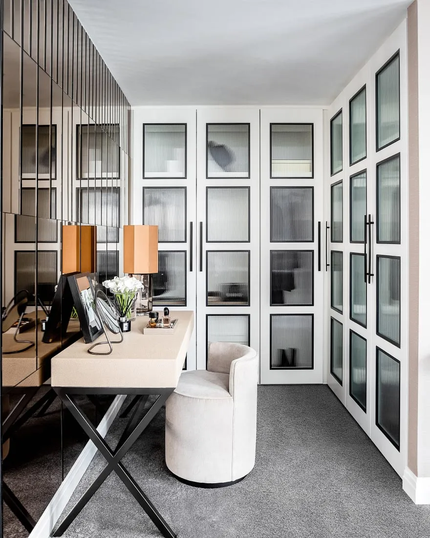 A modern office space featuring a white desk, steel details, and minimalist design.