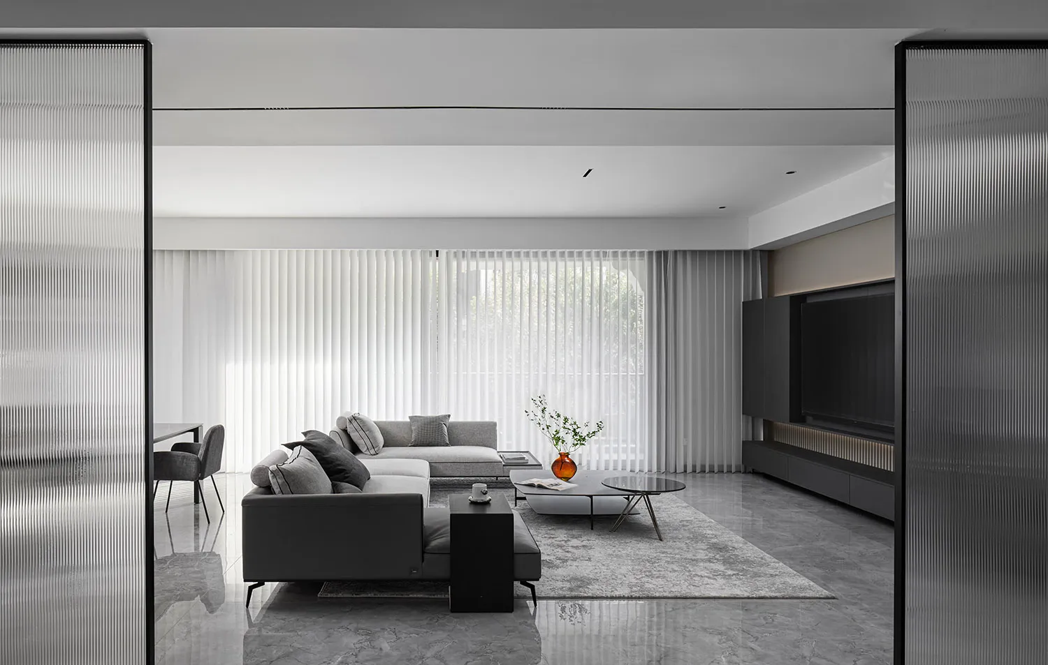 Modern minimalist living room featuring grey concrete furniture, large glass window, and sleek design.