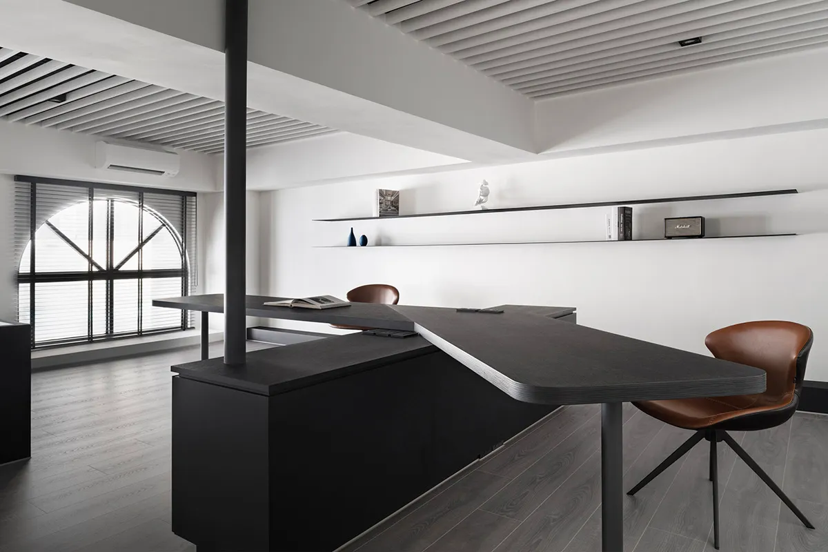 A modern office space featuring a dark wood counter with a sleek, minimalist design.