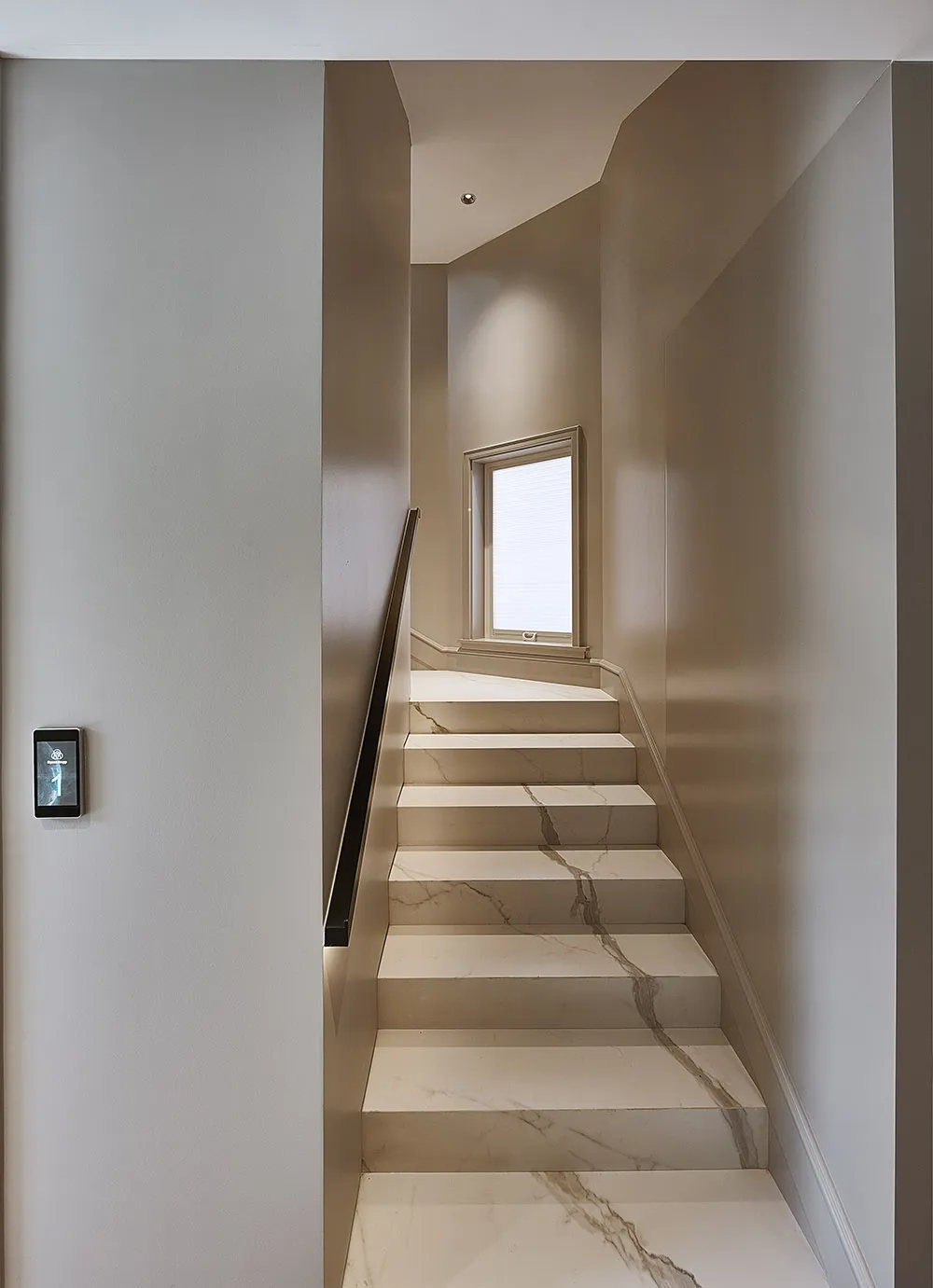 Modern, minimalist staircase with marble steps and walls