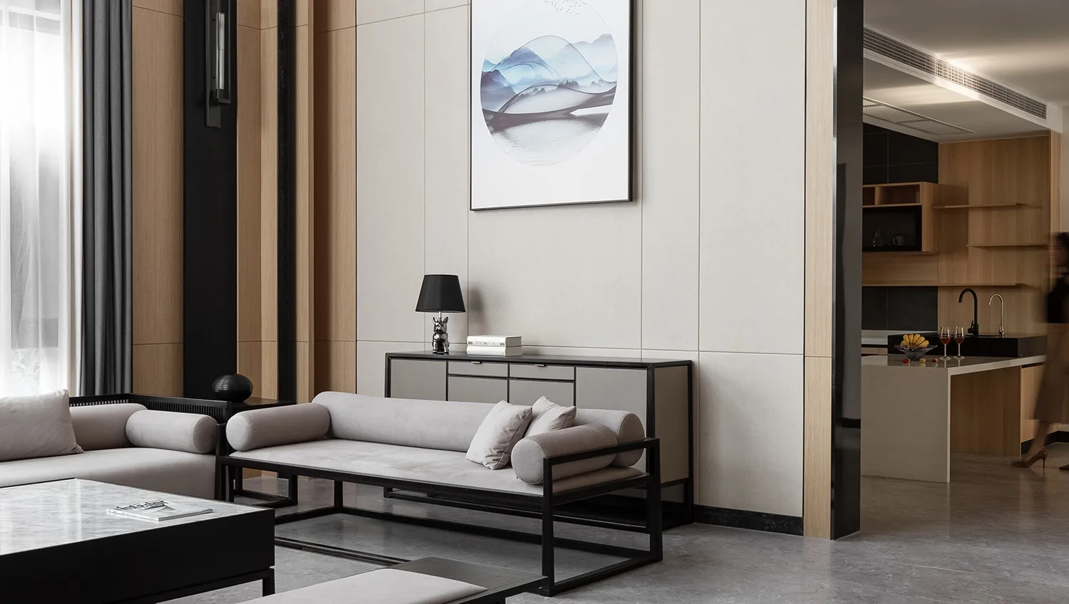 Modern minimalist living room with sleek black and white furniture and artwork.