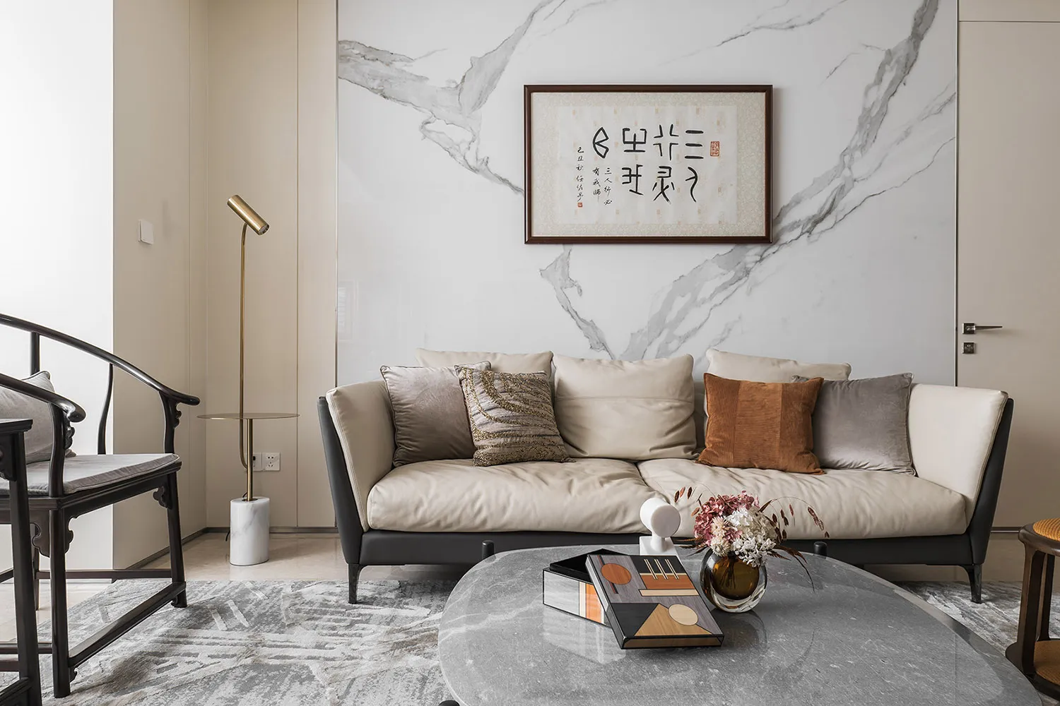 Modern living room with marble walls, a comfortable sofa, and a sleek coffee table.