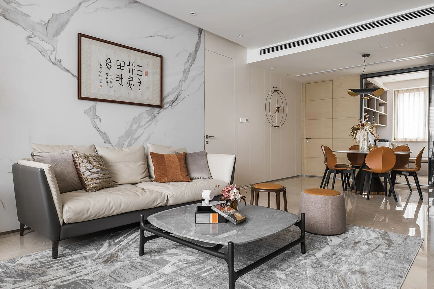 Modern living room featuring a marble sofa, leather accents, and wooden elements