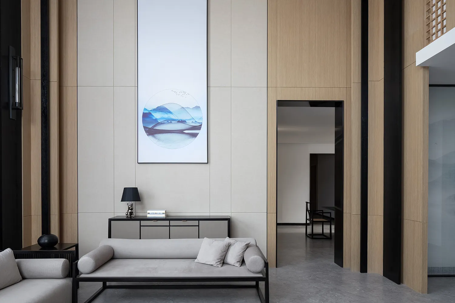 A modern minimalist living room features sleek, stylish furnishings, wood paneling, and a minimalist art piece.