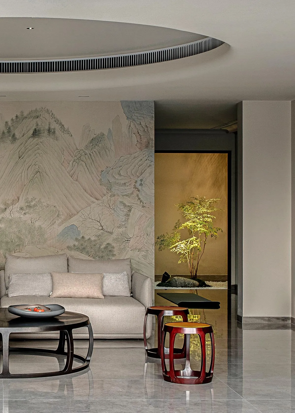 Contemporary living room with marble floors and furniture, featuring a large mural of mountains.