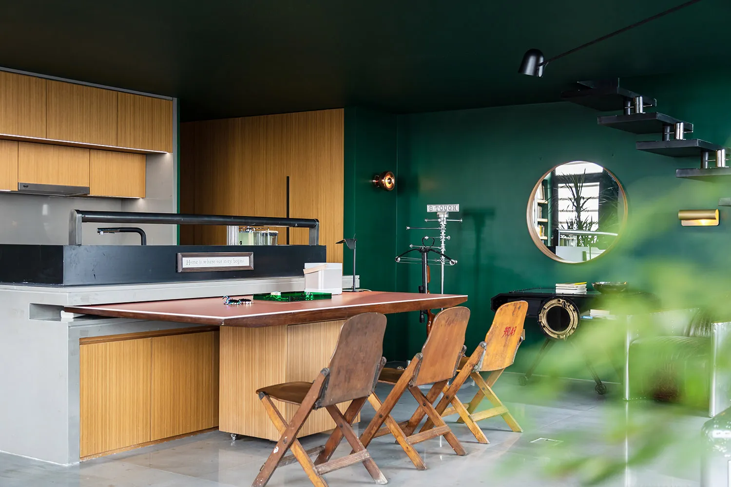 A modern kitchen with industrial design features including wooden furniture, concrete countertops, and metal accents.