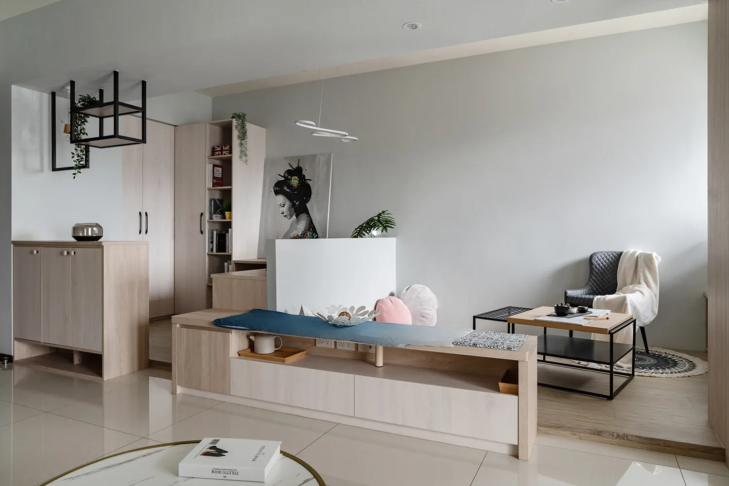 A modern minimalist living room with wooden furniture, concrete walls, and metal accents.