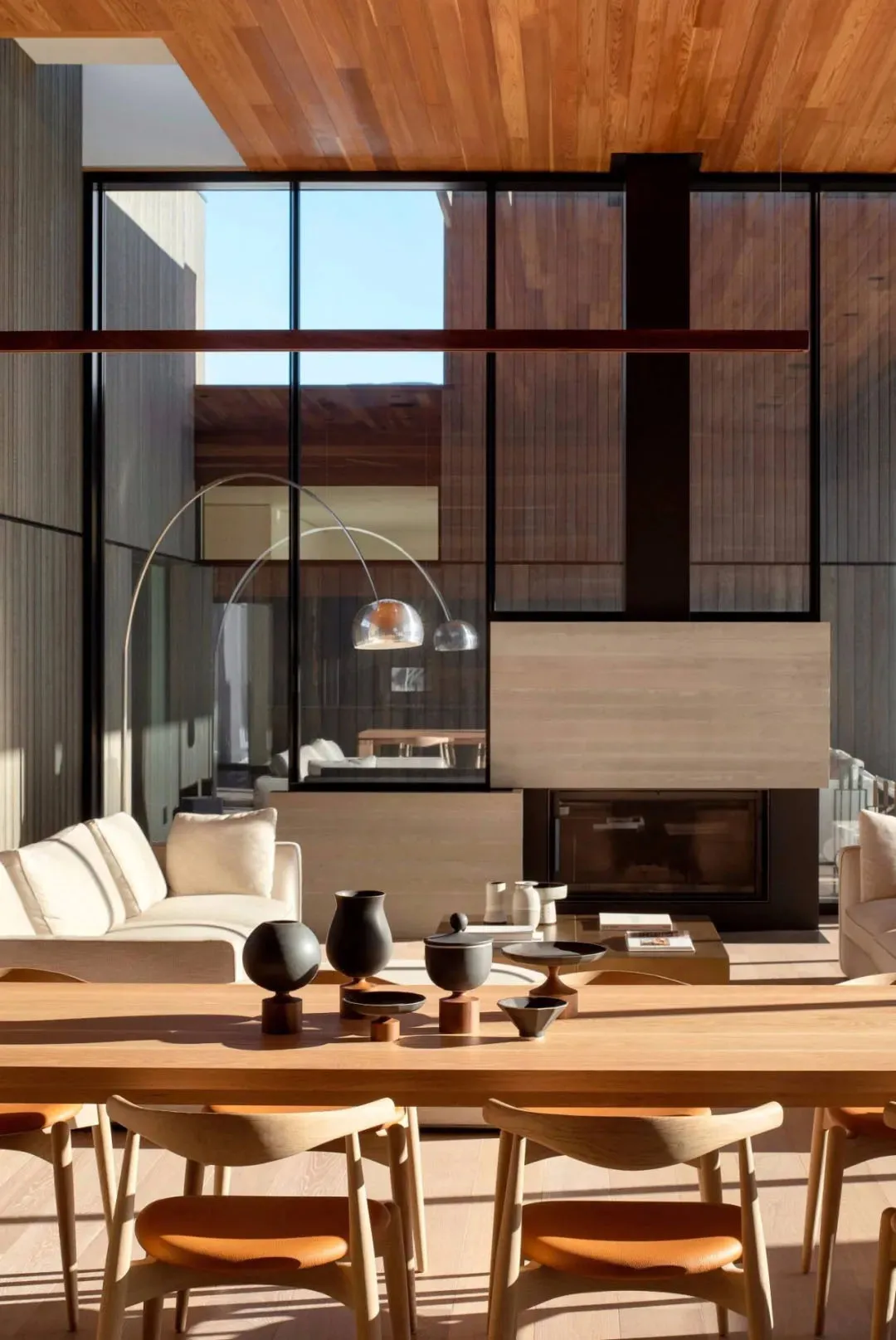 Modern living room with wooden furniture and floor-to-ceiling windows