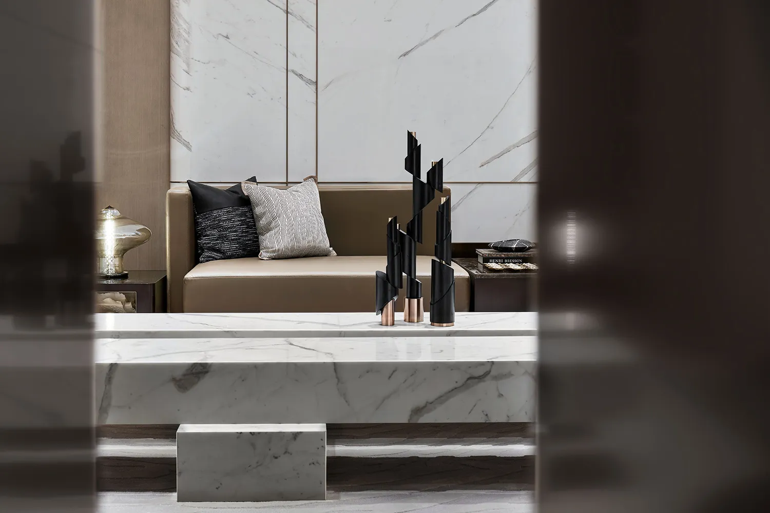 A modern living room featuring marble elements and contemporary decor.