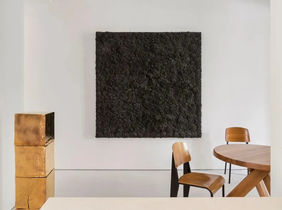 Minimalist living room with concrete walls and floor.