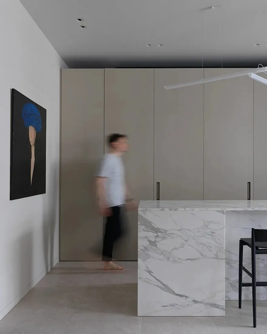 Modern residential kitchen featuring a striking marble countertop and minimalist design.