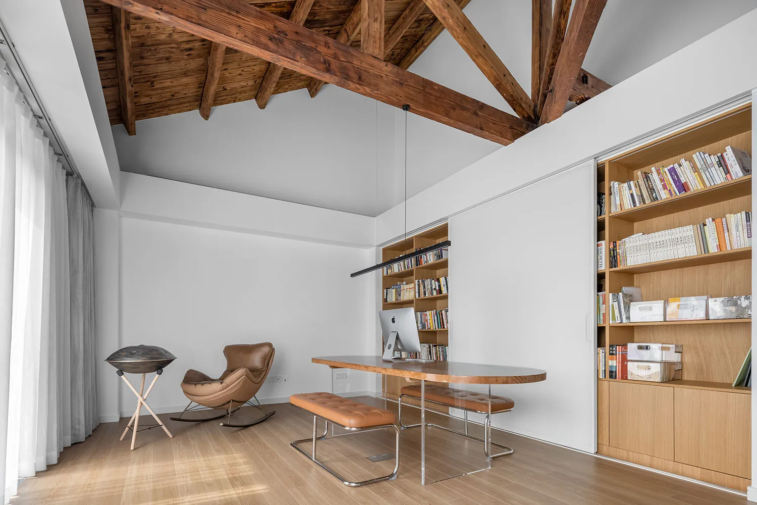 Minimalist home office featuring a wooden desk and bookshelf.