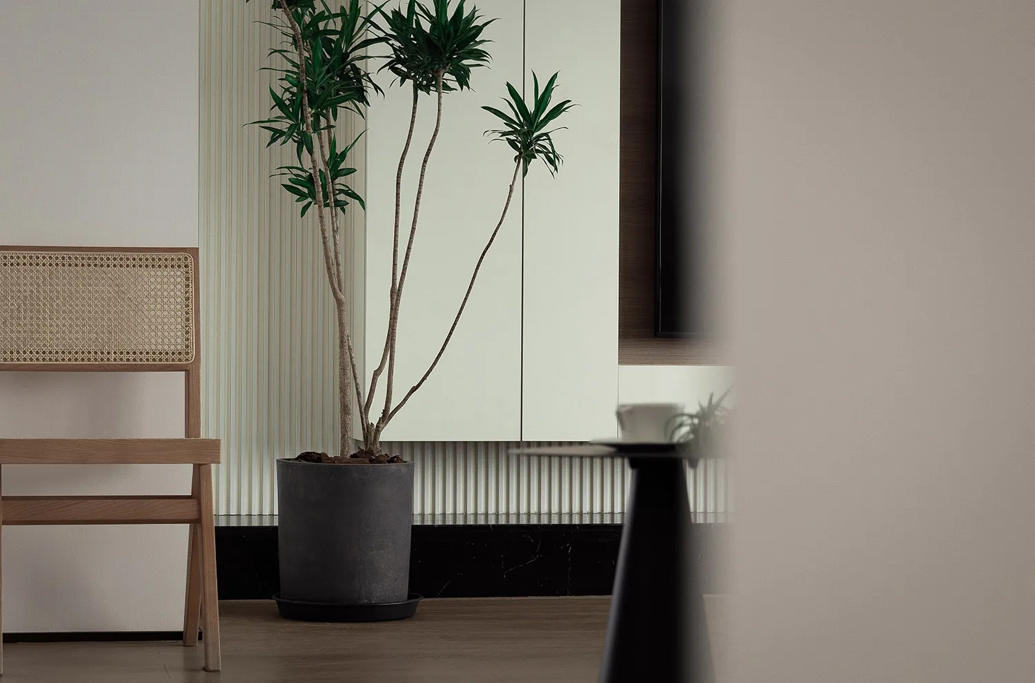 A minimalist living room featuring a modern floating shelf.