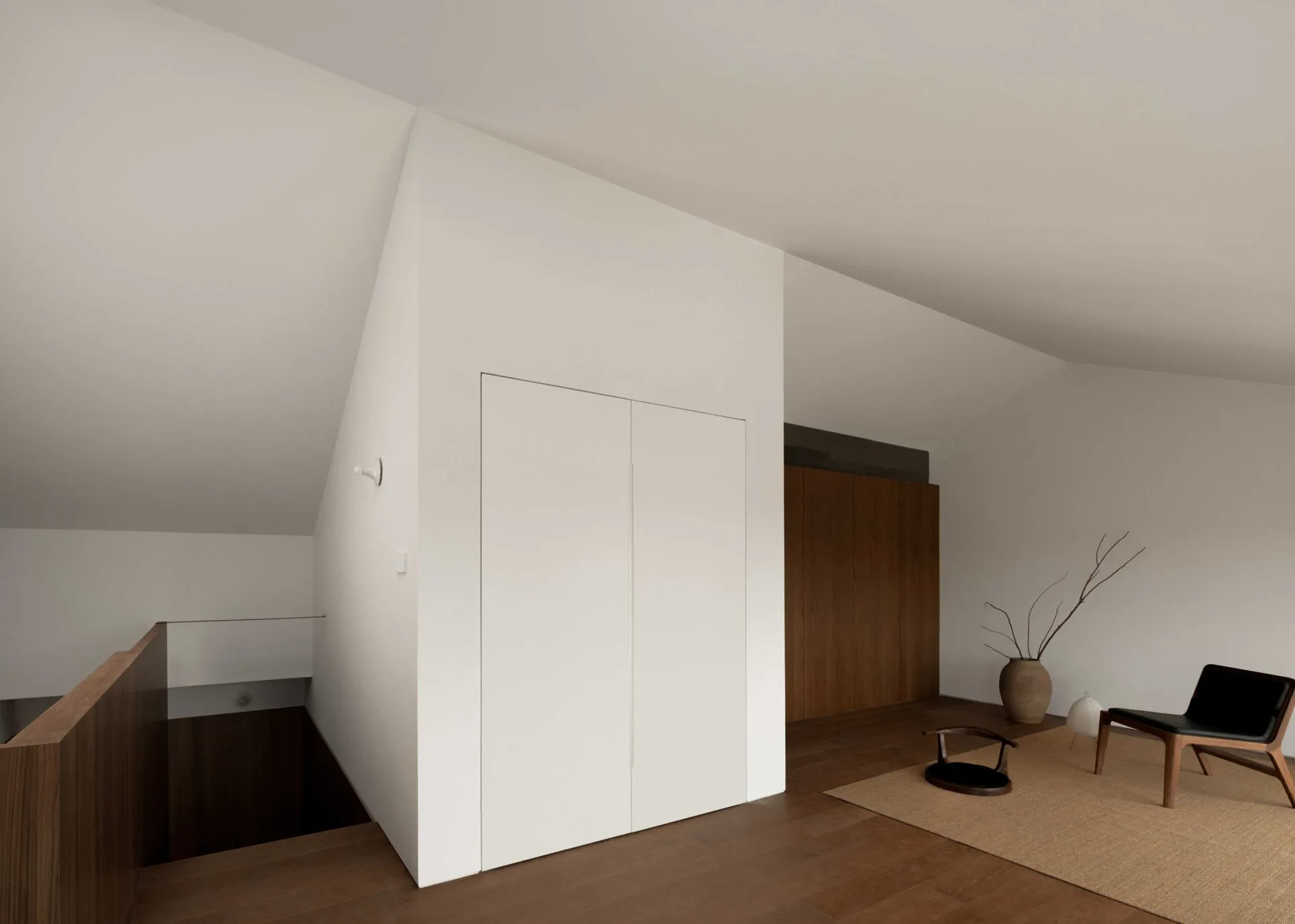 A minimalist residential interior with white walls and wood accents.