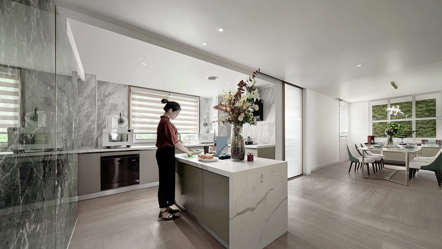 A modern kitchen with marble countertops and stainless steel appliances.