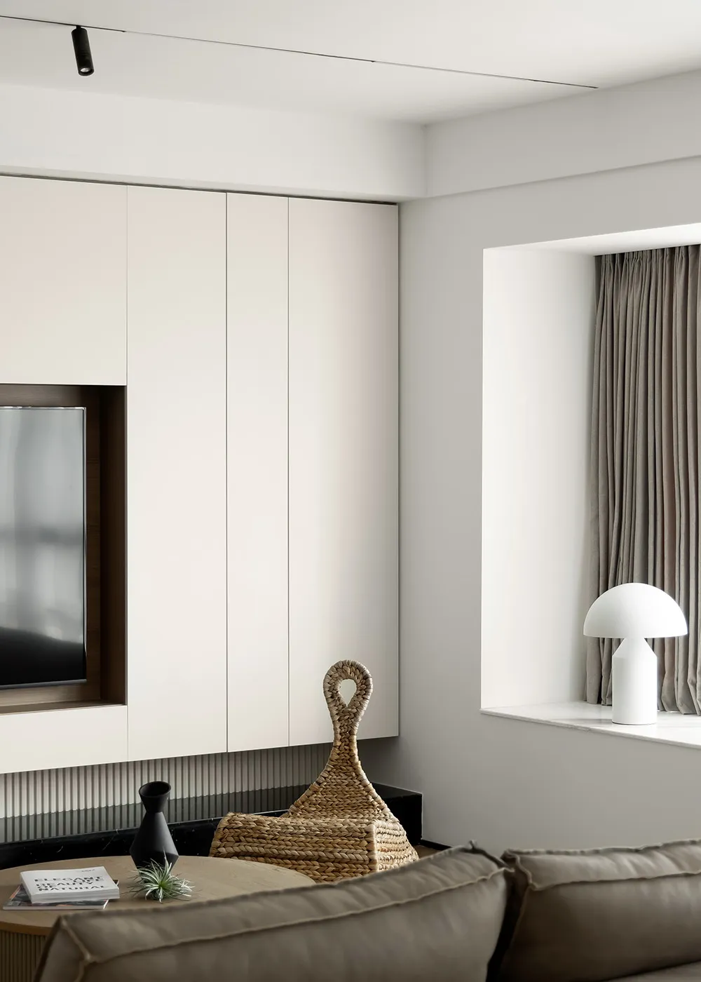 Minimalist living room with neutral tones, sleek furniture, and clean lines.