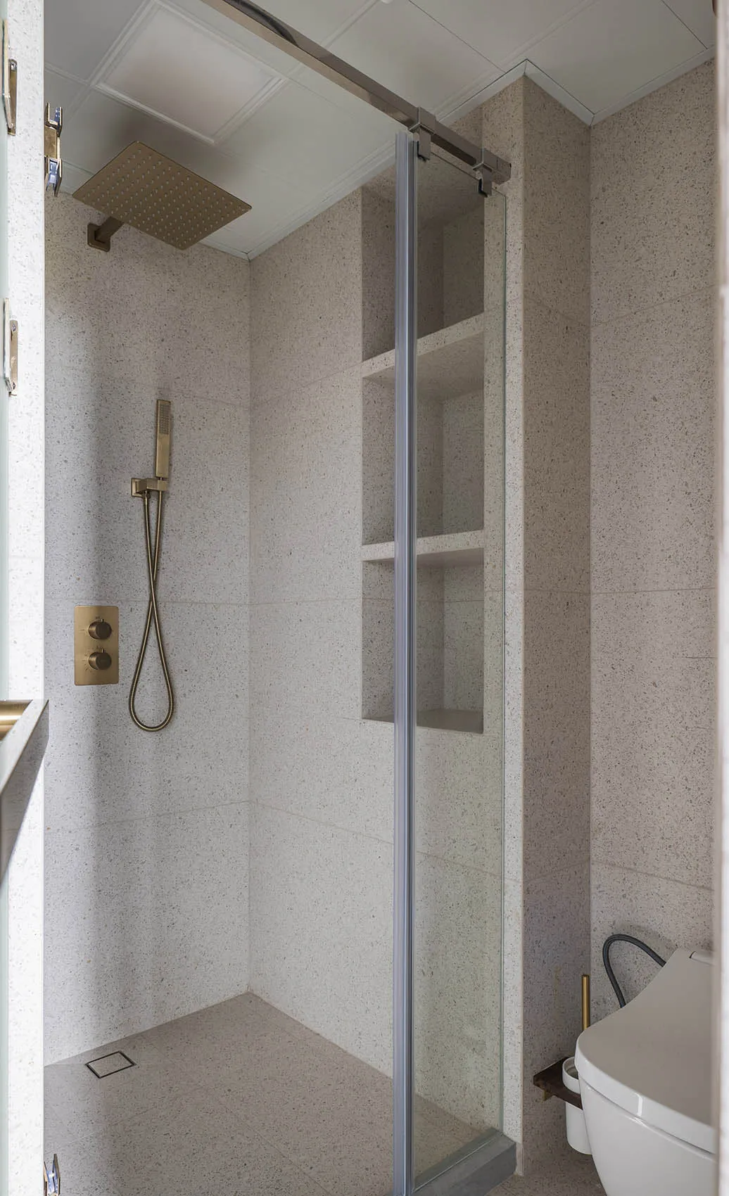 A sleek, modern bathroom with concrete tiles on the floor and walls.