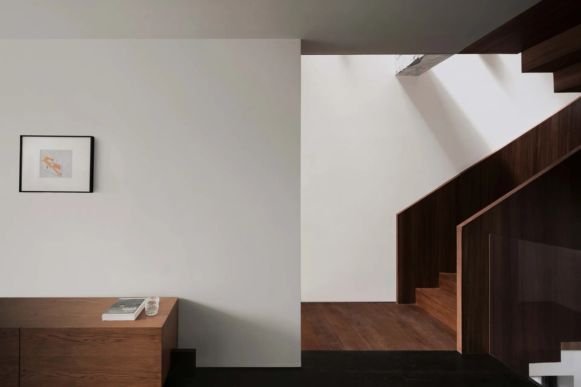 A modern minimalist staircase with black and white color scheme.
