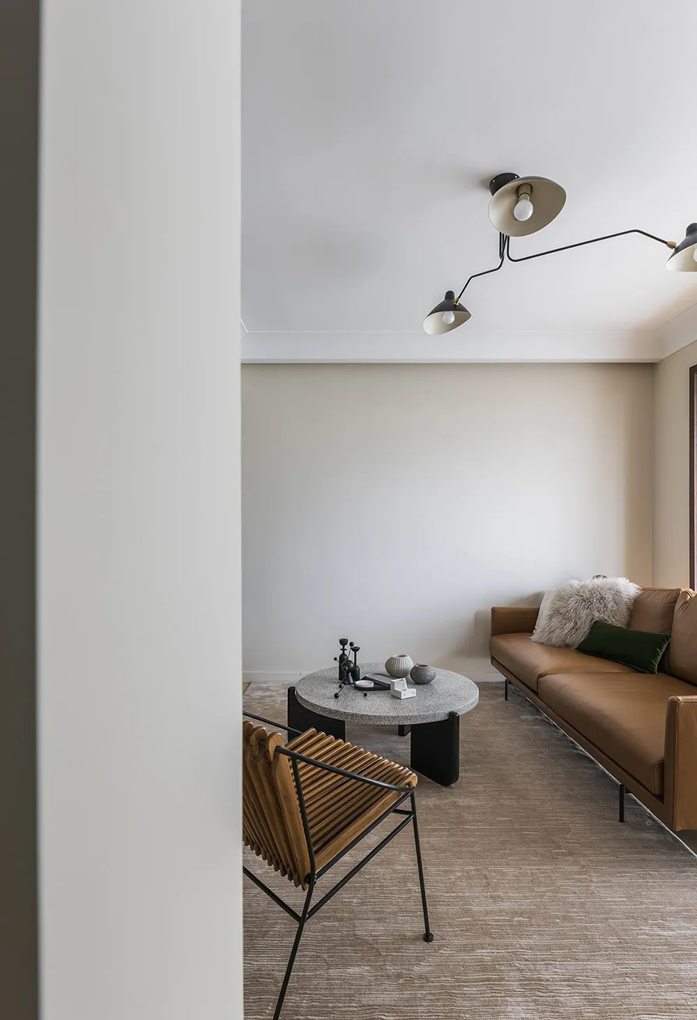 Modern living room featuring a brown leather couch with concrete coffee table.