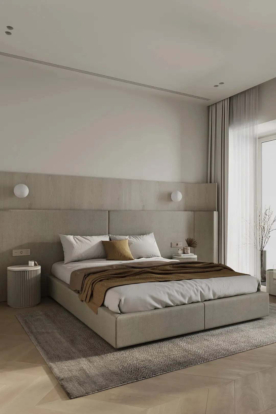 A minimalist bedroom with a fabric upholstered bed, white walls, and a large window with light-colored curtains.