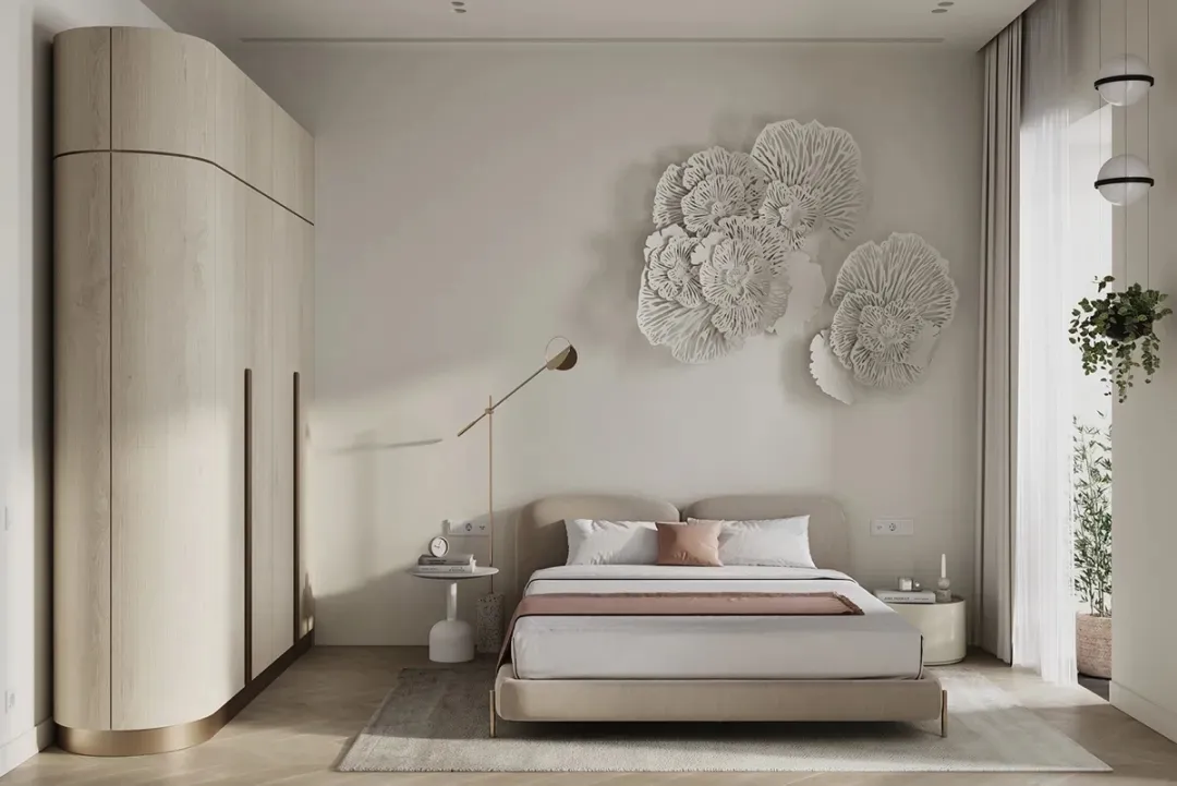 A bedroom with a neutral color palette featuring a bed, nightstand, and decorative wall art.